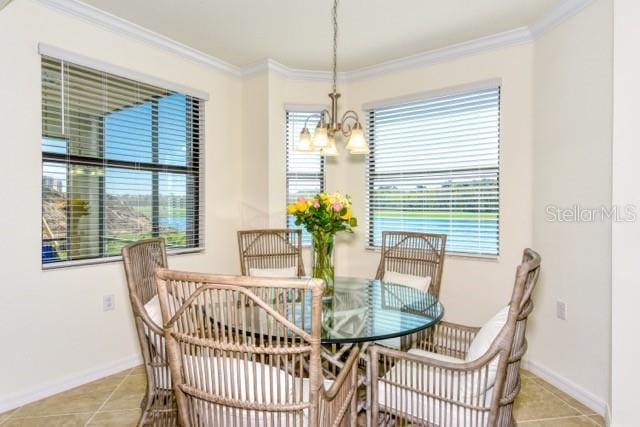 dining area featuring ornamental molding, an inviting chandelier, plenty of natural light, and light tile patterned floors