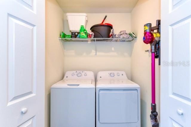 washroom with washer and dryer