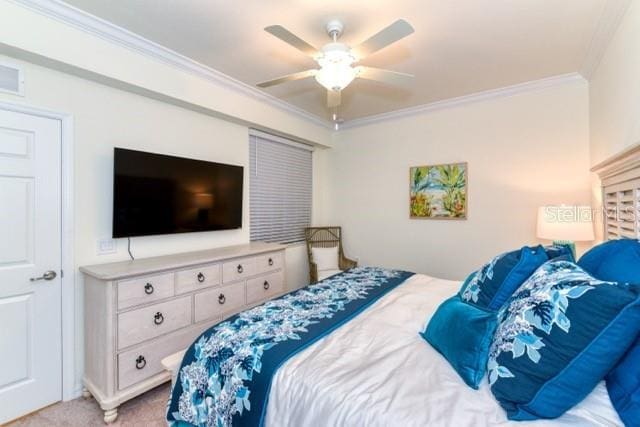 bedroom with ceiling fan, ornamental molding, and light carpet