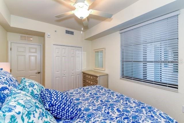 bedroom featuring ceiling fan and a closet