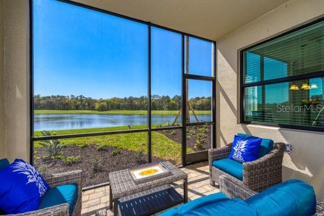 sunroom / solarium featuring a water view