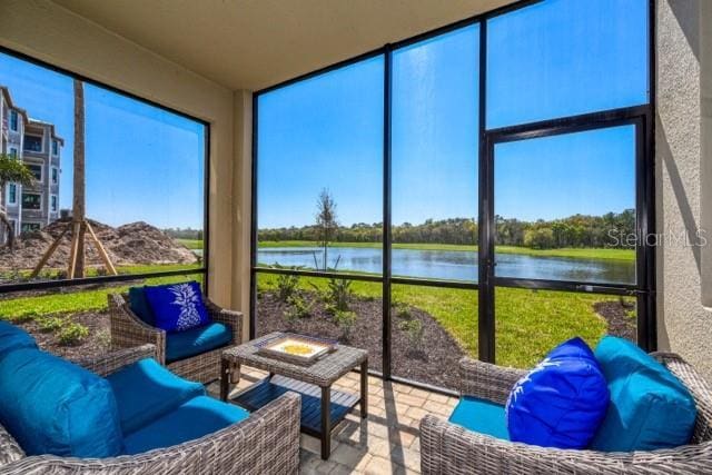 sunroom / solarium with a healthy amount of sunlight and a water view