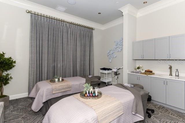 bedroom featuring ornamental molding and sink