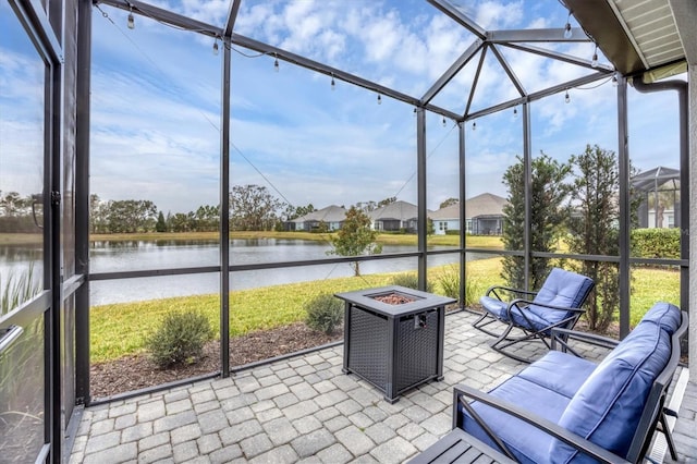 unfurnished sunroom featuring a water view