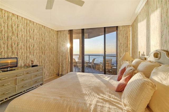 bedroom featuring ceiling fan, access to exterior, a water view, and ornamental molding