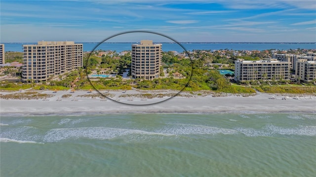 birds eye view of property with a water view and a view of the beach