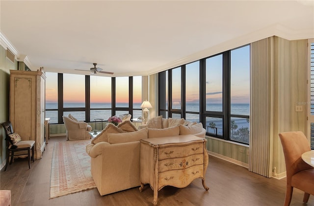 living room with ceiling fan, ornamental molding, a water view, and hardwood / wood-style floors