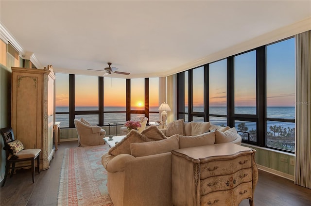 living room with ceiling fan, ornamental molding, a water view, and wood-type flooring