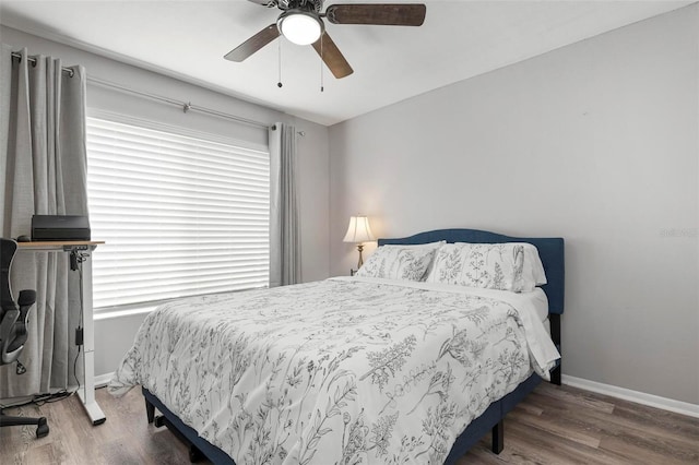 bedroom with ceiling fan and wood-type flooring