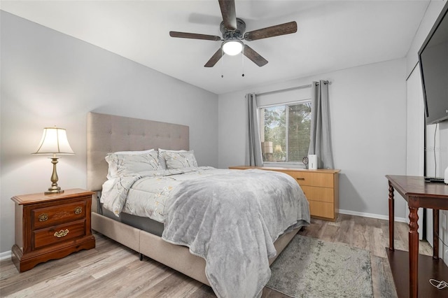 bedroom with ceiling fan and light hardwood / wood-style flooring