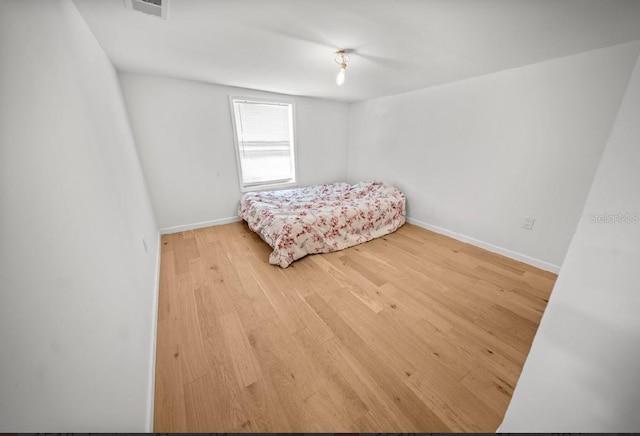 bedroom with hardwood / wood-style floors