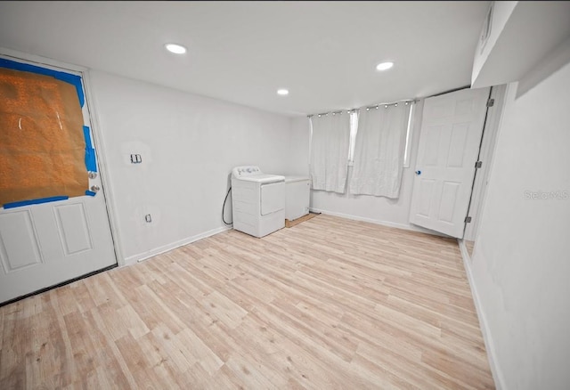 clothes washing area featuring light hardwood / wood-style floors and washing machine and clothes dryer