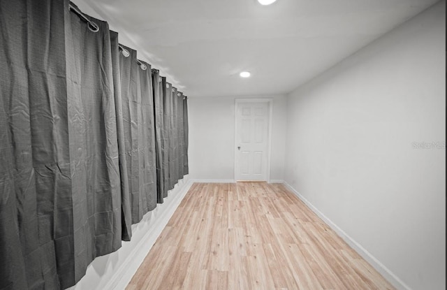 corridor with light hardwood / wood-style flooring