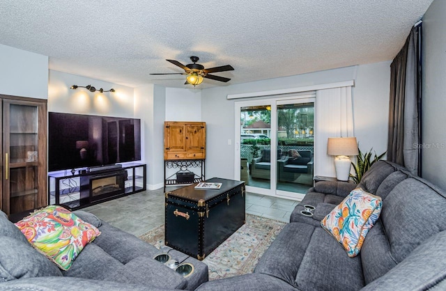 living room featuring a textured ceiling and ceiling fan