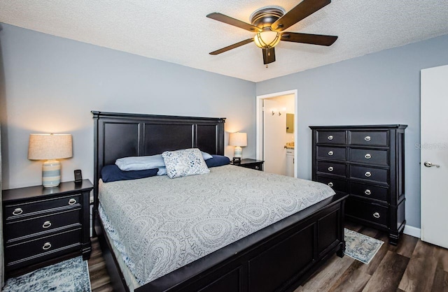 bedroom with ensuite bathroom, dark hardwood / wood-style flooring, a textured ceiling, and ceiling fan