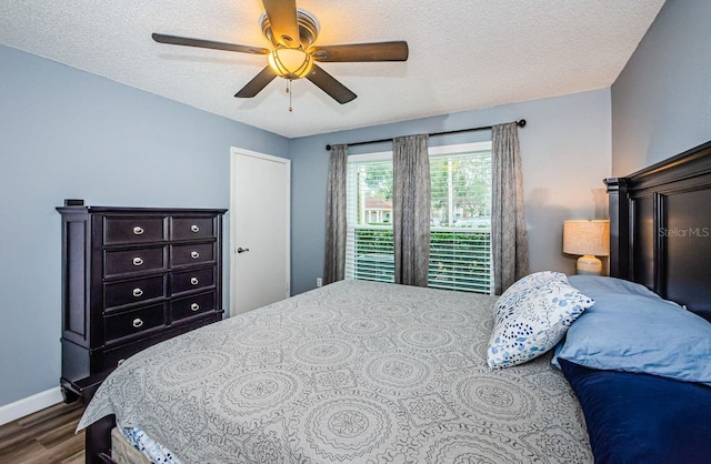 bedroom featuring ceiling fan, a textured ceiling, and hardwood / wood-style flooring