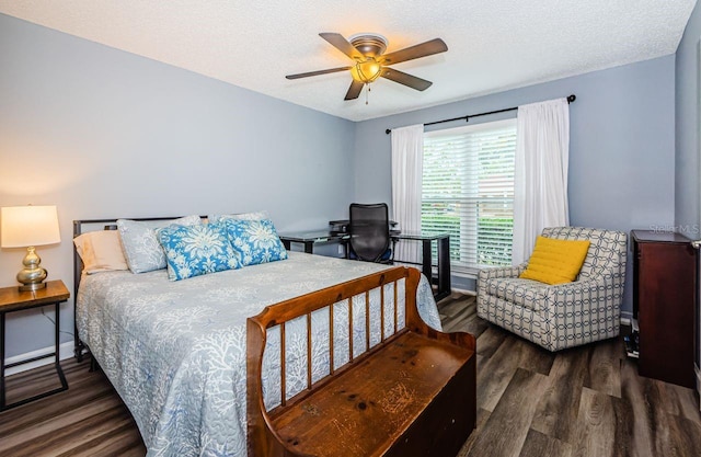 bedroom with dark wood-type flooring, a textured ceiling, and ceiling fan