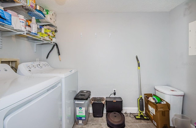 washroom with washer and dryer and a textured ceiling