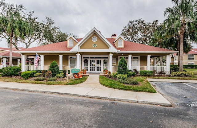 view of front of property with french doors and covered porch