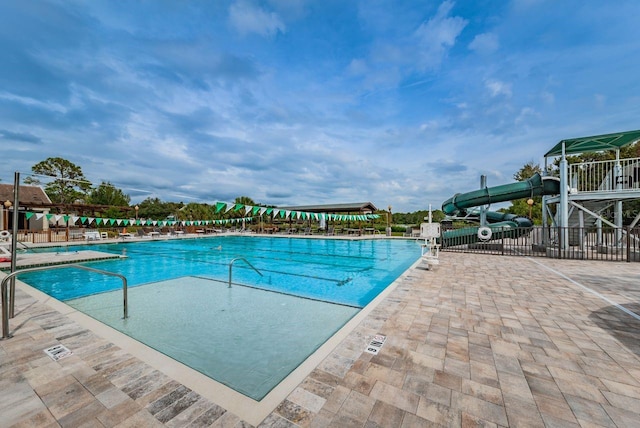 view of swimming pool with a water slide