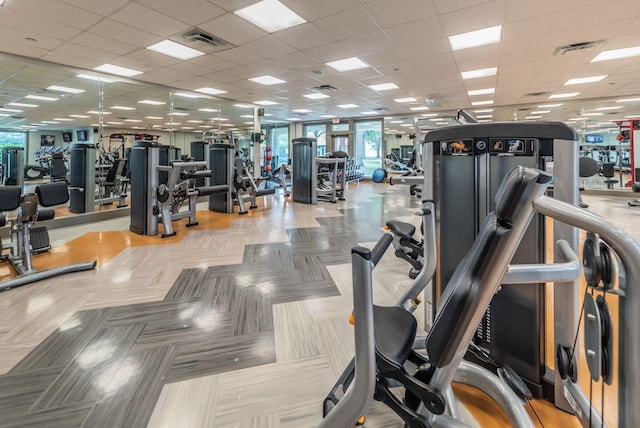 workout area featuring a paneled ceiling