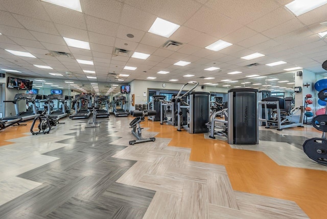 gym with hardwood / wood-style floors and a drop ceiling