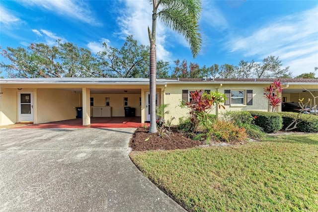 ranch-style house with a front yard and a carport