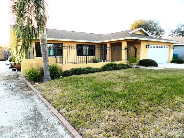 ranch-style house featuring a front lawn and a garage