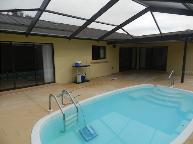 pool with a patio area and a lanai