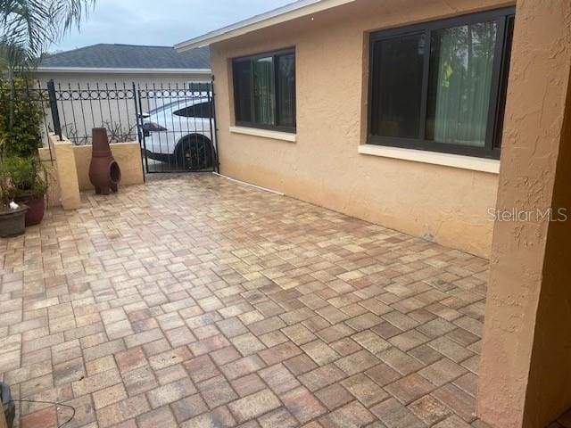 view of patio / terrace featuring a gate and fence