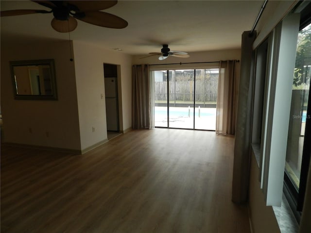 empty room with baseboards and wood finished floors