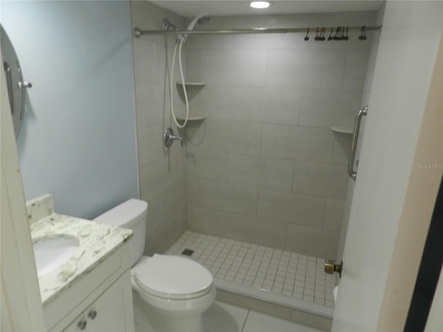 full bath with vanity, a shower stall, and toilet