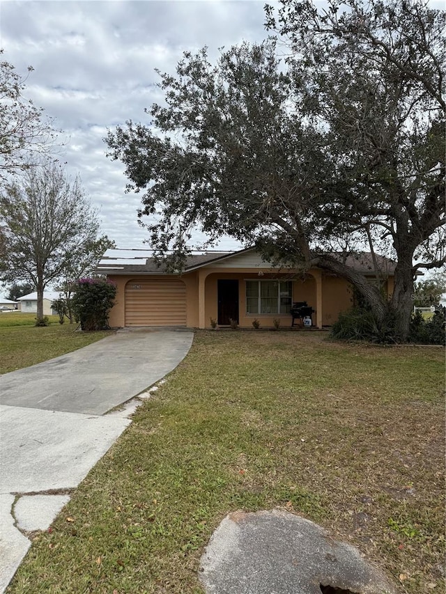 view of front facade with a garage and a front lawn