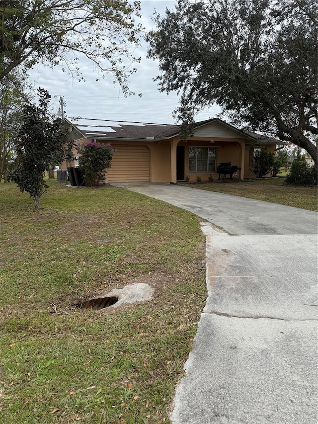 view of front of property featuring a garage and a front lawn