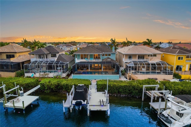 view of dock with a swimming pool and a water view