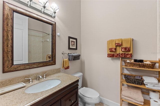 bathroom with toilet, a shower, and vanity