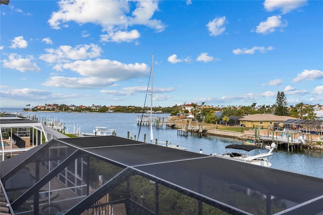 view of dock with a lanai and a water view