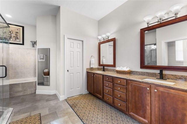 bathroom featuring an enclosed shower and vanity