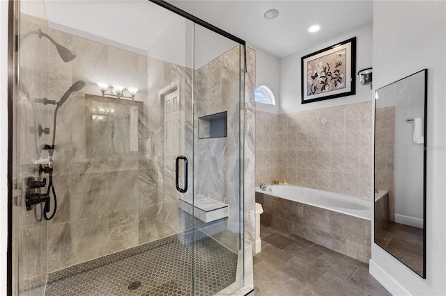 bathroom featuring shower with separate bathtub