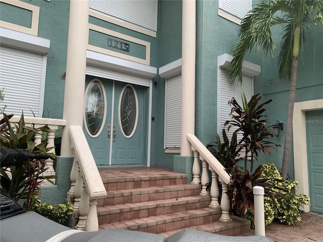 1215 Acappella Ln, Apollo Beach, FL 33572 - property entrance featuring a garage and stucco siding