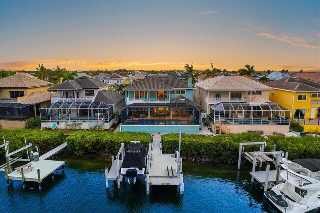 1215 Acappella Ln, Apollo Beach, FL 33572 - dock with boat lift, an outdoor pool, a water view, a residential view, and glass enclosure
