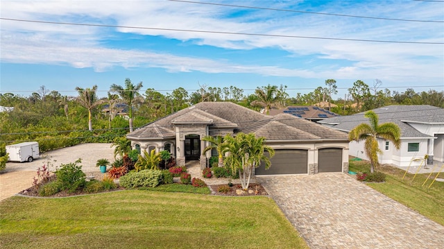 view of front of home featuring a front yard and a garage