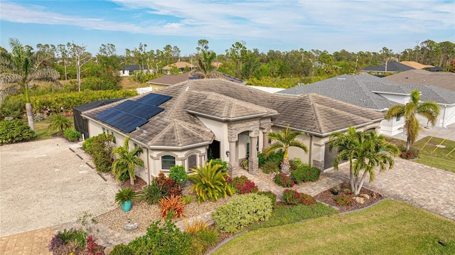 view of front of property featuring solar panels