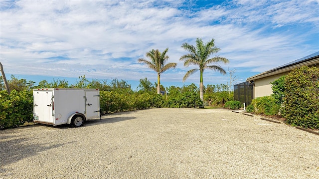 view of yard with glass enclosure