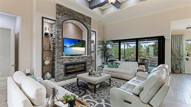 living room featuring a towering ceiling, ceiling fan, ornamental molding, and parquet flooring