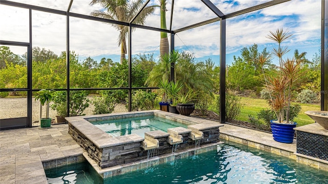 view of pool featuring a patio, pool water feature, glass enclosure, and an in ground hot tub