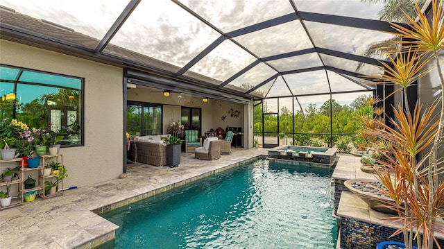 view of pool featuring an outdoor hangout area, a lanai, a patio area, and an in ground hot tub