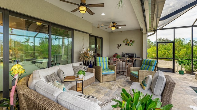 sunroom featuring a healthy amount of sunlight and ceiling fan