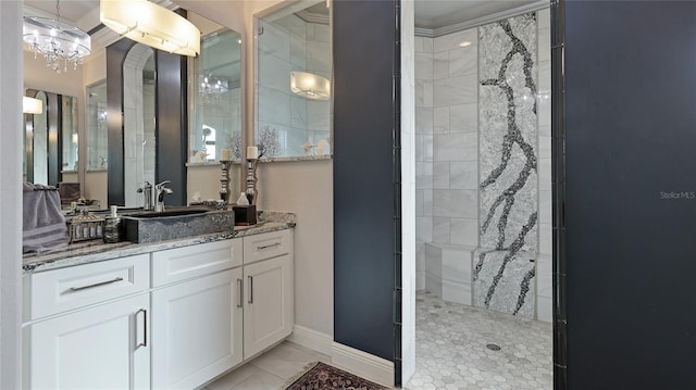 bathroom with vanity, tiled shower, and tile patterned floors