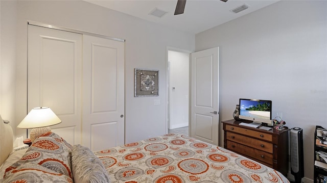 bedroom with ceiling fan and a closet